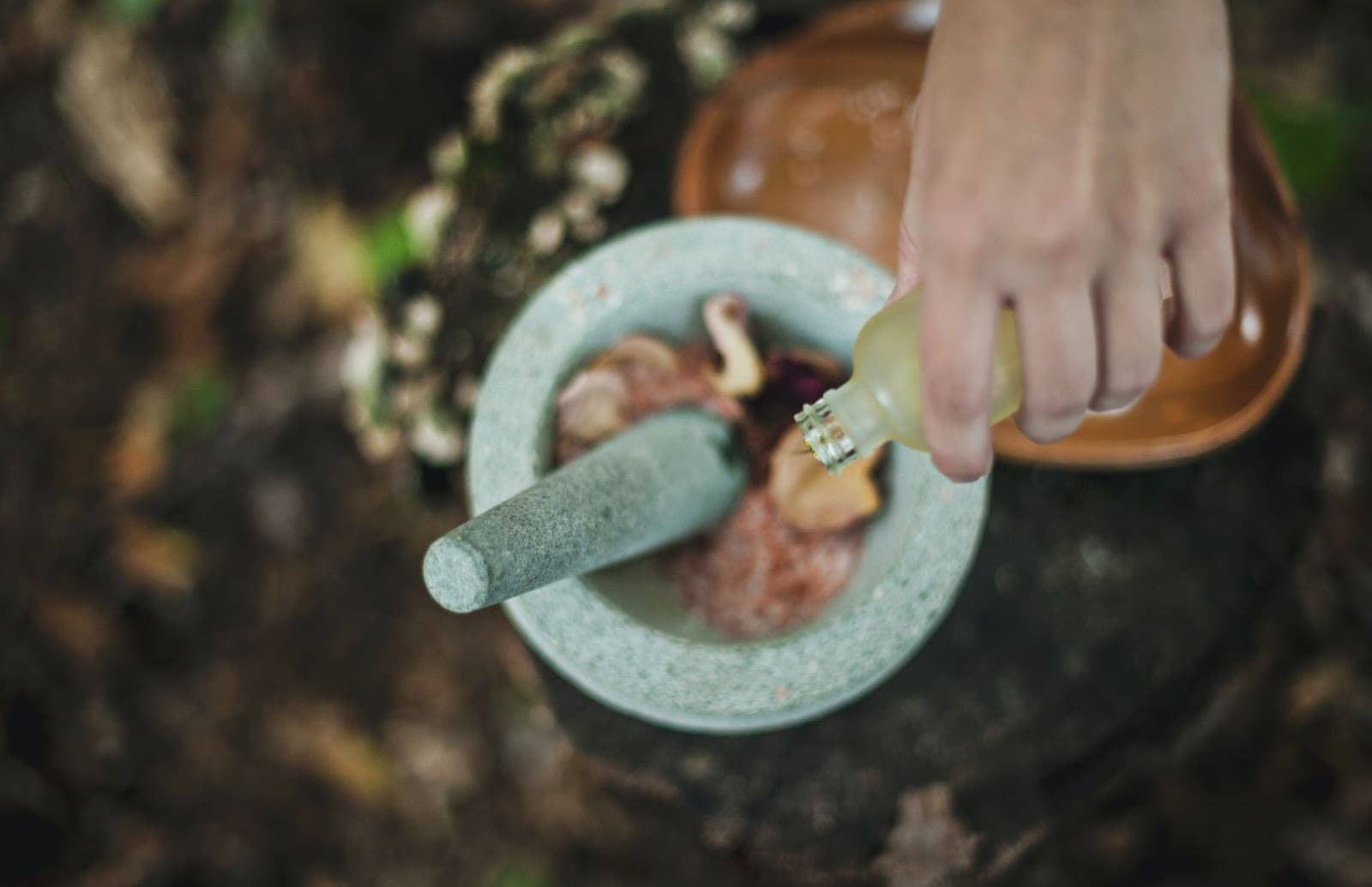 Essential Oil being poured into pestle and mortar